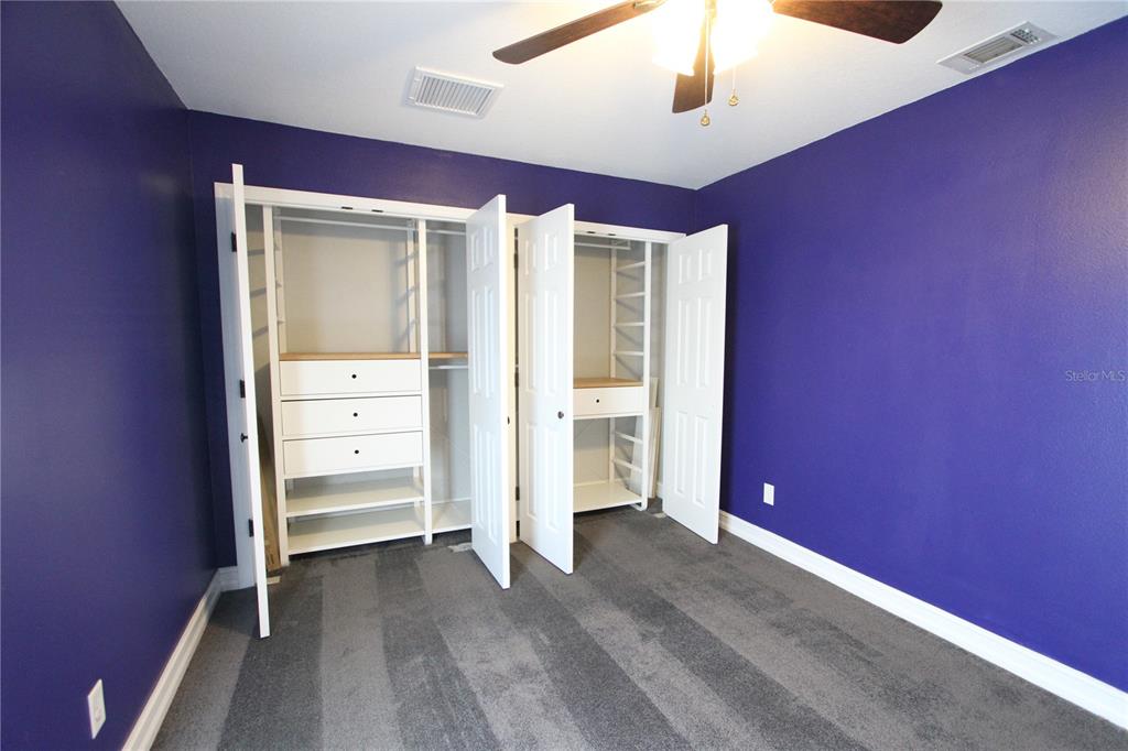 1414 Norwick Drive Lutz, FL 33559 - Photo 27 of 43 an empty room with closet and windows
