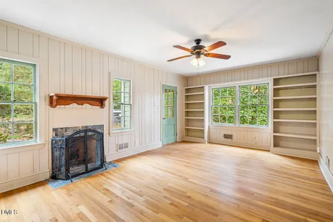 a view of empty room with a fireplace and fan