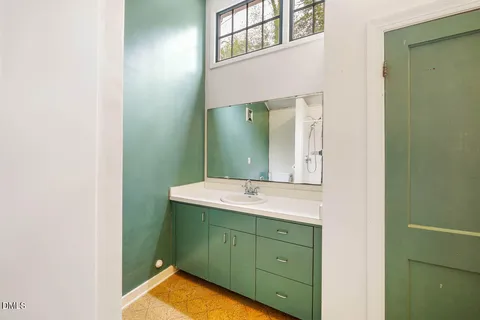 a bathroom with a sink and mirror
