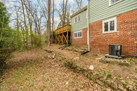 a view of a brick house with a yard
