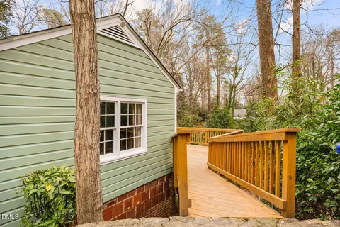 a view of a small house with wooden fence