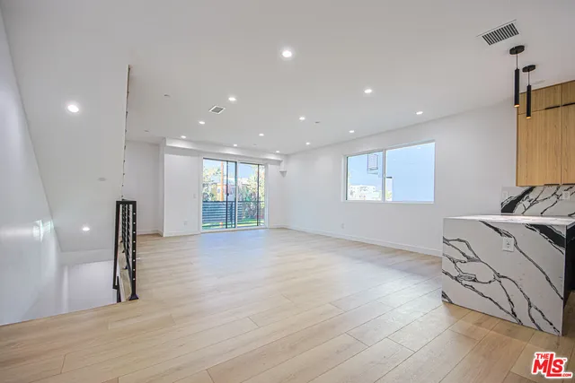 a bathroom with a granite countertop sink a toilet and a mirror