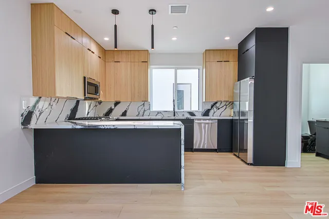 a view of a hallway with washer and dryer