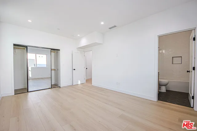 a bathroom with a sink a toilet a mirror and bathtub