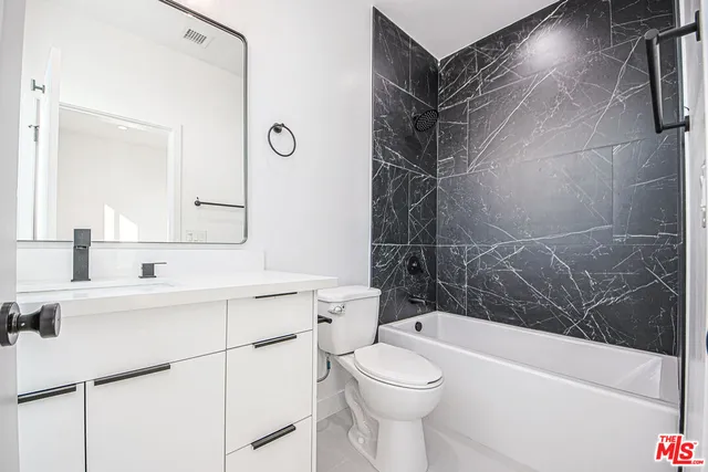 a view of a hallway with wooden floor and windows