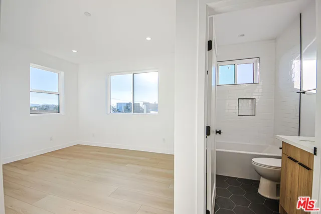 a view of kitchen with refrigerator and window