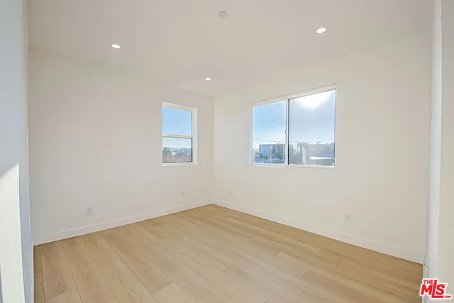 a kitchen with granite countertop a refrigerator sink and cabinets