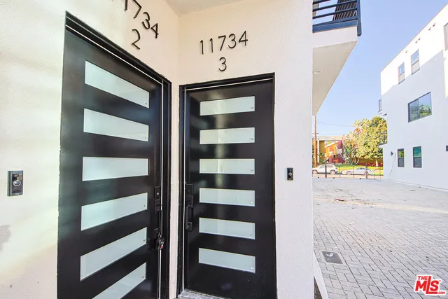 a view of a room with wooden floor and windows
