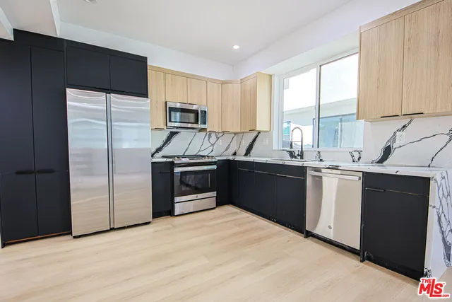 an aerial view of residential houses with yard and ocean view