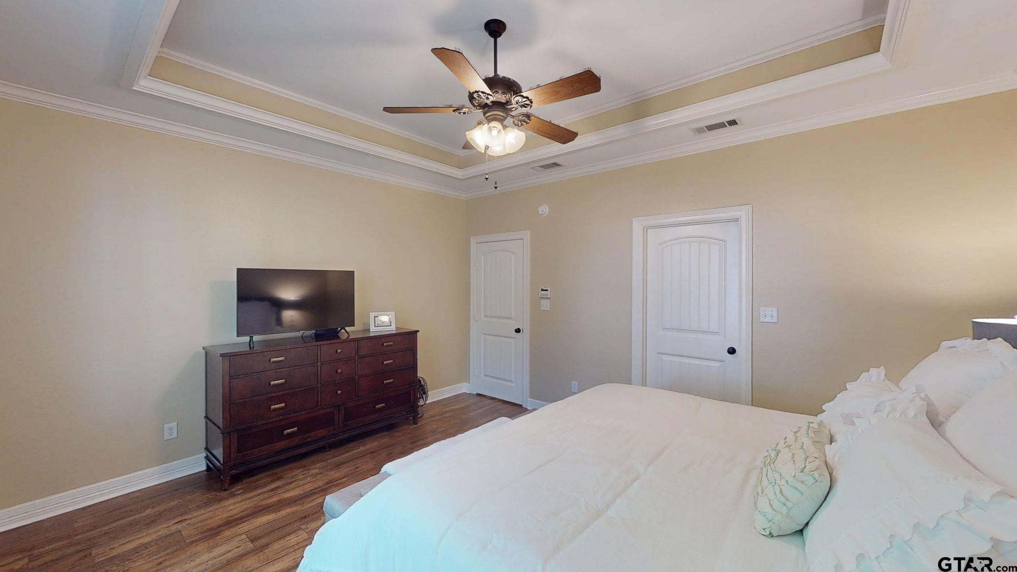 18488 Bluebird Circle Flint, TX 75762 - Photo 21 of 47 a bedroom with a bed and a flat tv screen on dresser
