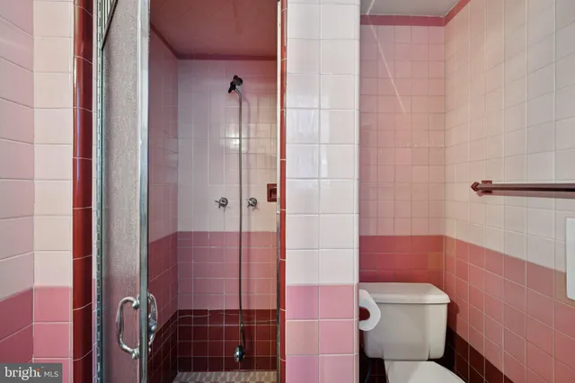 a view of a hallway with wooden floor and windows