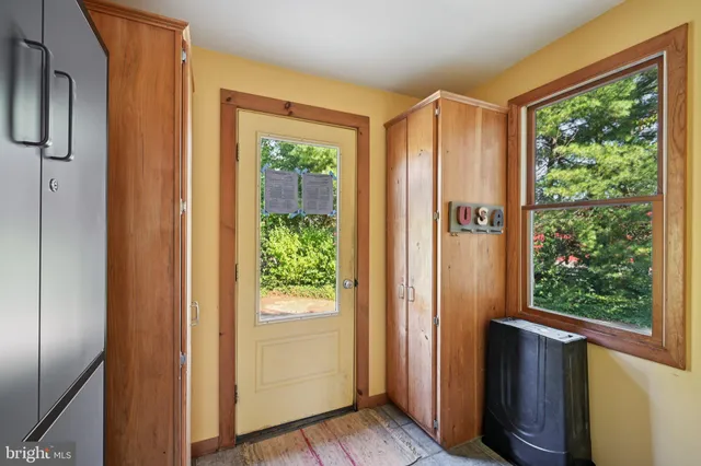 a view of a room with workspace and a window