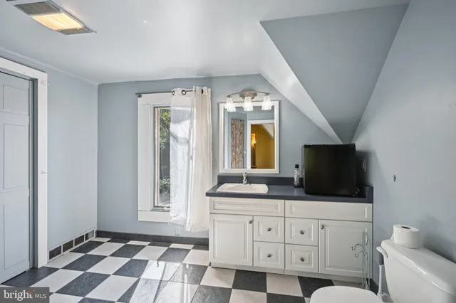 a bedroom with furniture and a window