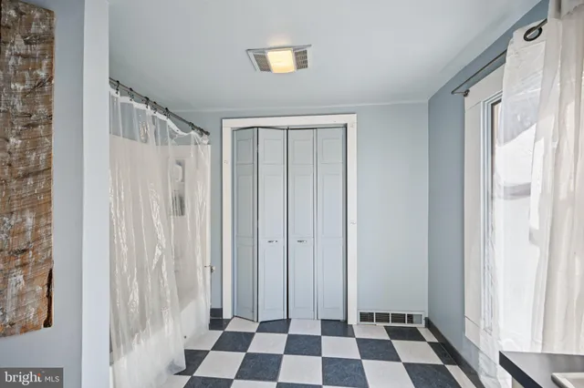 an aerial view of a house with a yard and trees