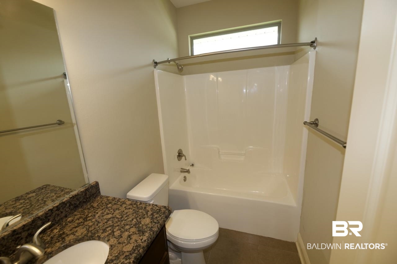 22640 Nana Loop East Silverhill, AL 36576 - Photo 38 of 46 Full bathroom featuring toilet, bathtub / shower combination, vanity, and tile patterned floors