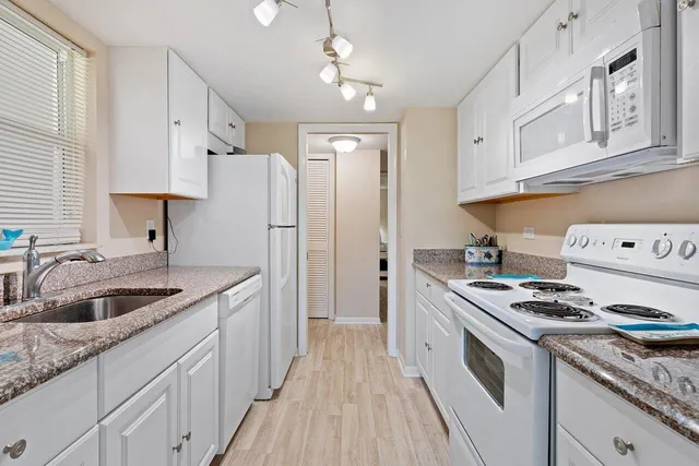 a kitchen with stainless steel appliances granite countertop a stove and a refrigerator