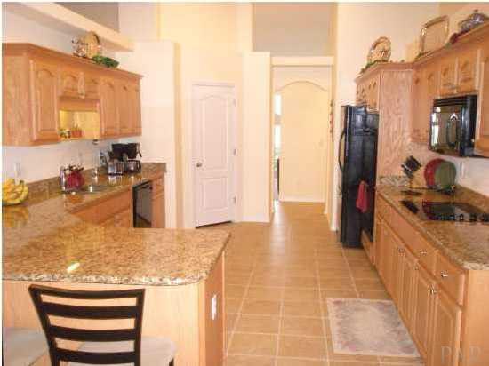 7564 Loop Street Navarre, FL 32566 - Photo 3 of 15 Spectacular Gourmet Kitchen With Granite Counter Tops, Maple Cabinets With Crown Molding And Upgraded "Kenmore" Appliances With Double Oven