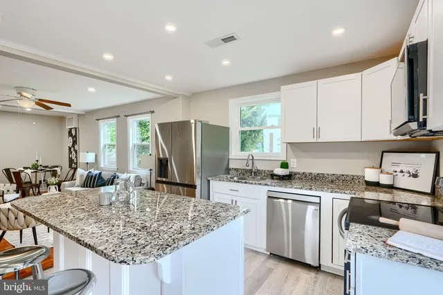 a kitchen with granite countertop a sink and cabinets