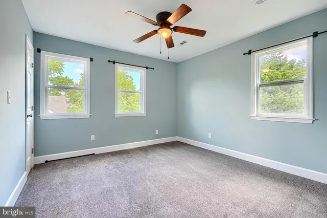 a view of room with window and ceiling fan