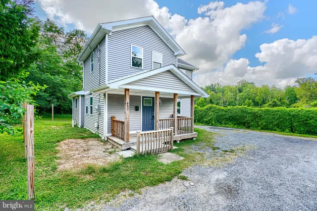 a view of a house with yard and a garden