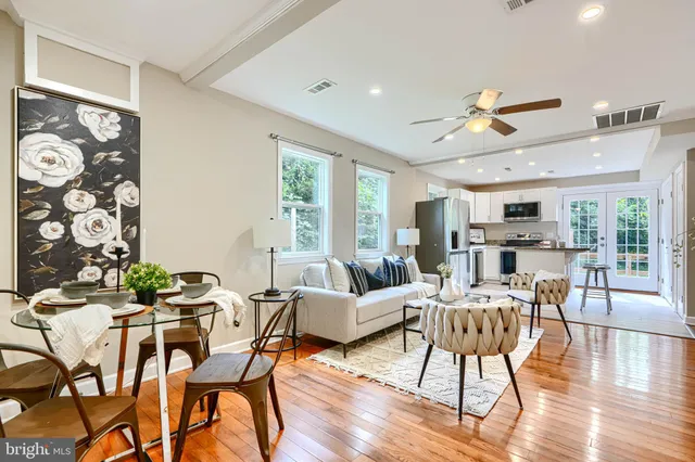 a living room with furniture and wooden floor