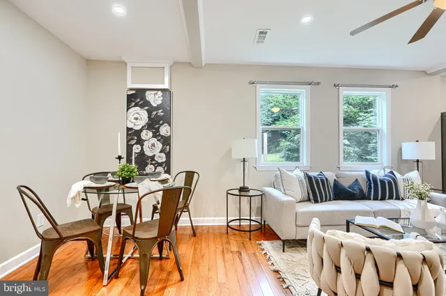 a living room with furniture and floor to ceiling windows