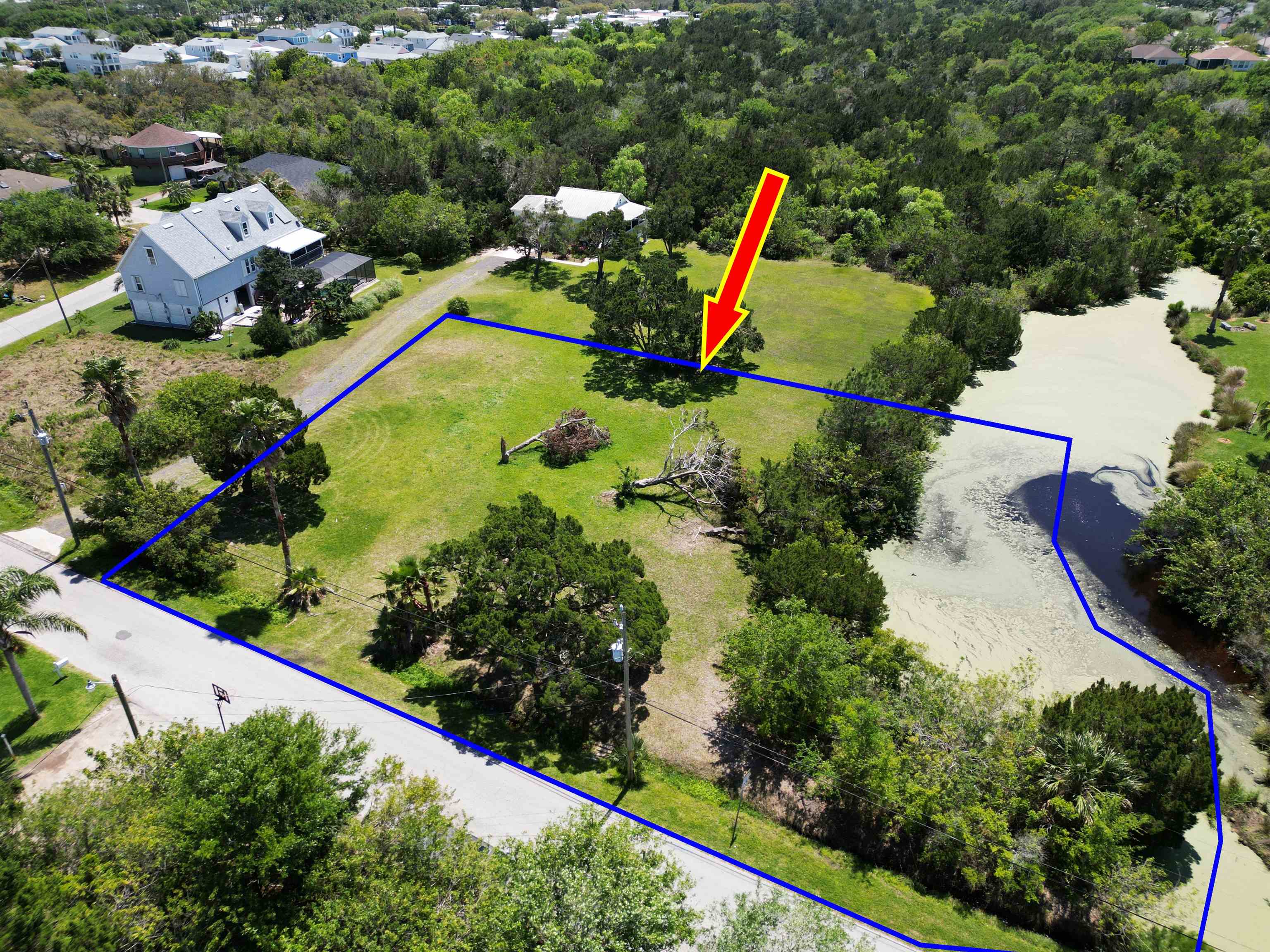 an aerial view of a house with swimming pool and garden