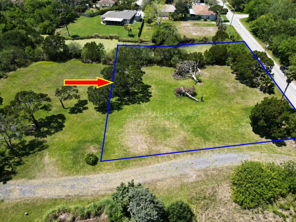 an aerial view of a residential houses with outdoor space and street view
