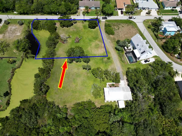 an aerial view of a house with a garden and swimming pool