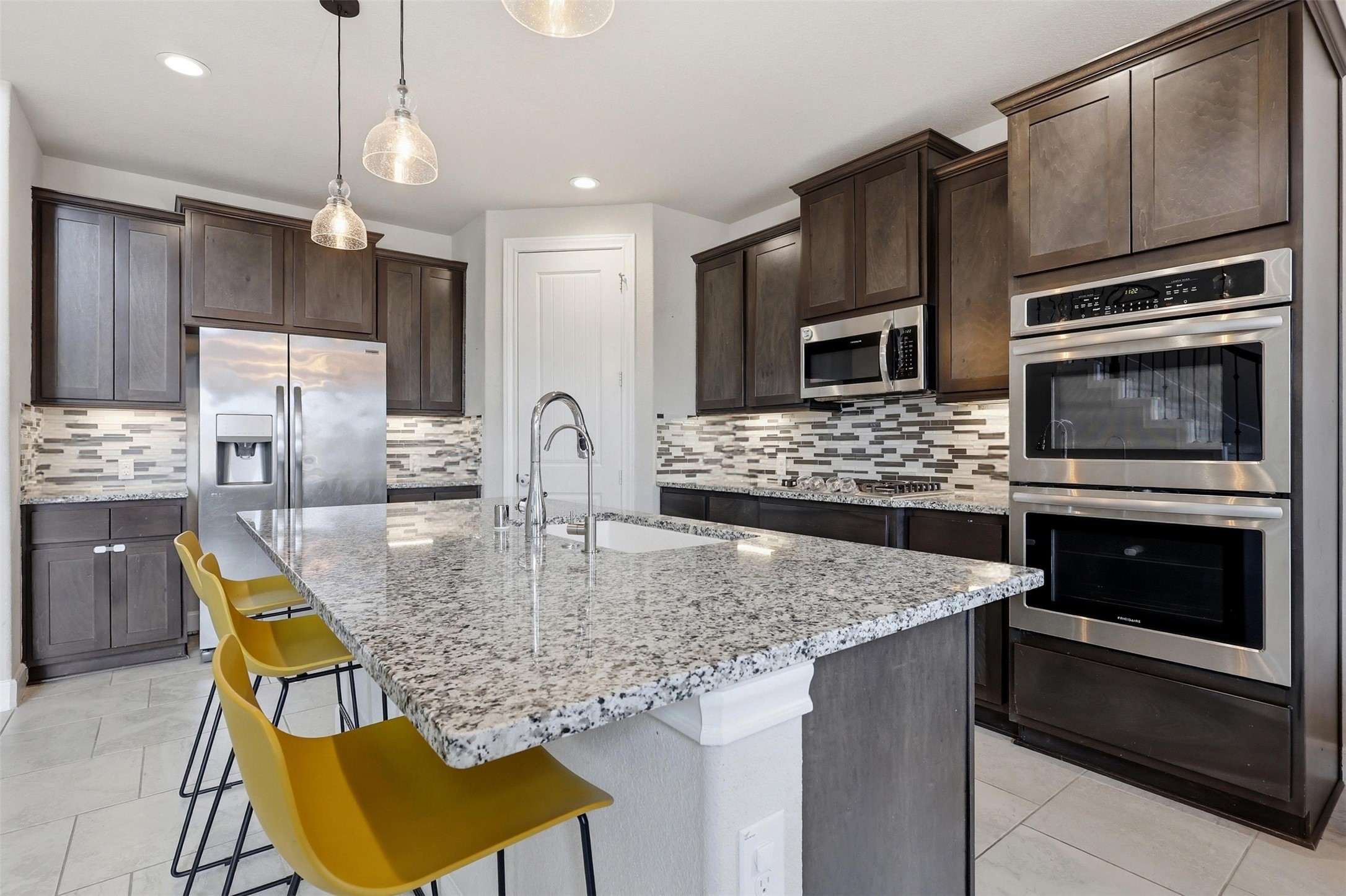 5803 Metaphor Way Rosenberg, TX 77469 - Photo 6 of 37 Chef inspired kitchen with granite countertops and under the cabinet lighting.