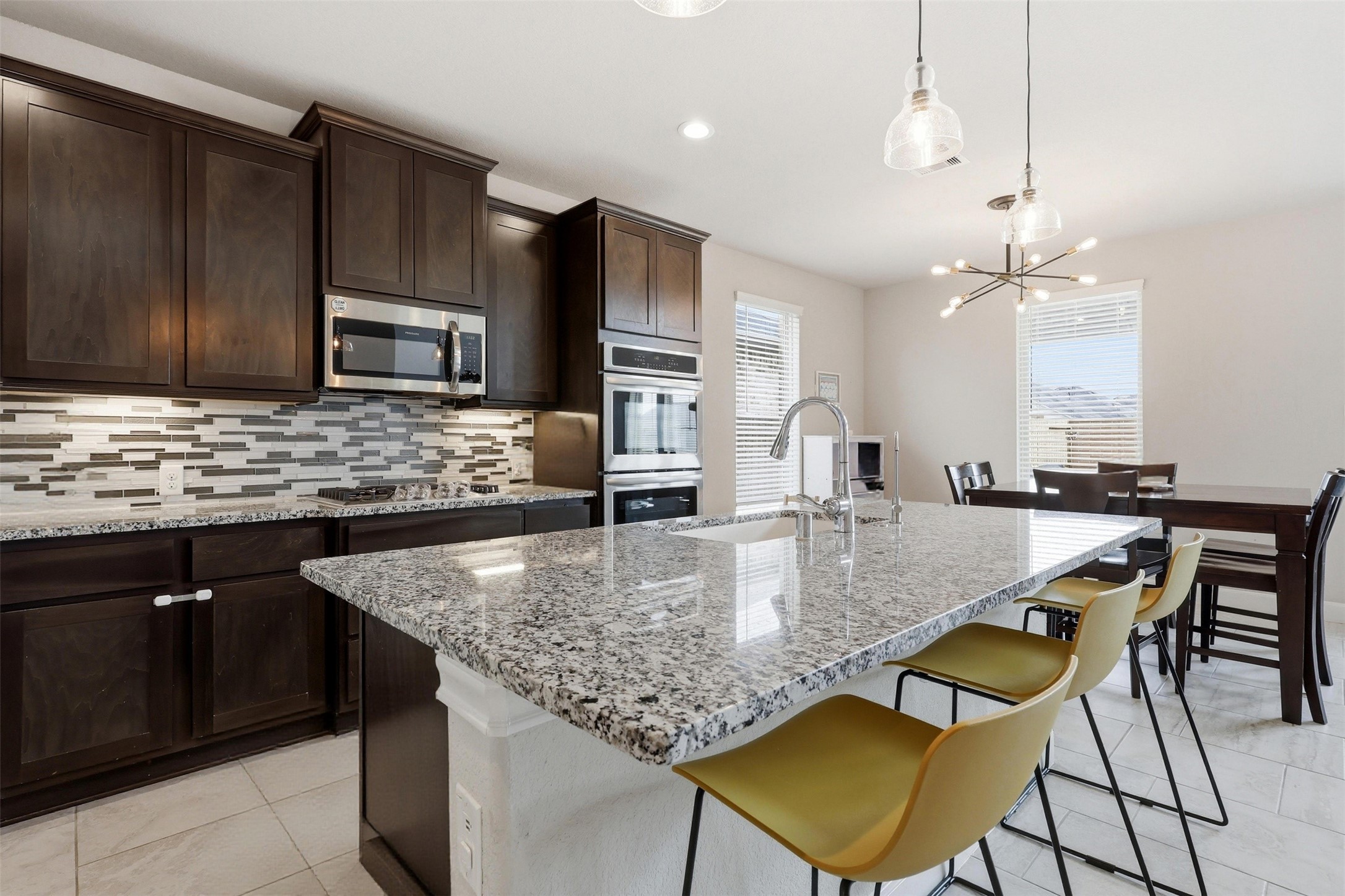 5803 Metaphor Way Rosenberg, TX 77469 - Photo 9 of 37 Efficient bar stools for morning breakfast and/or evening meals.