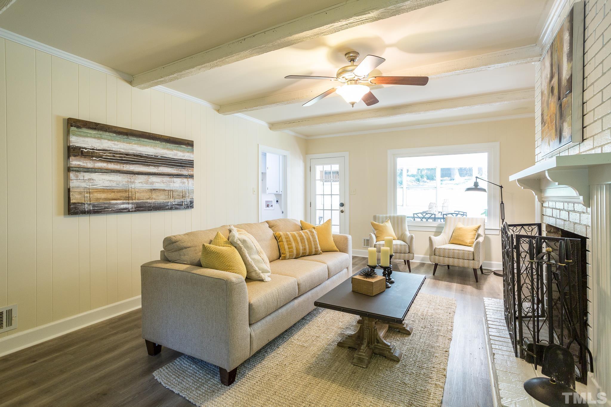 4608 Oak Park Road Raleigh, NC 27612 - Photo 11 of 30 a living room with furniture large window and wooden floor