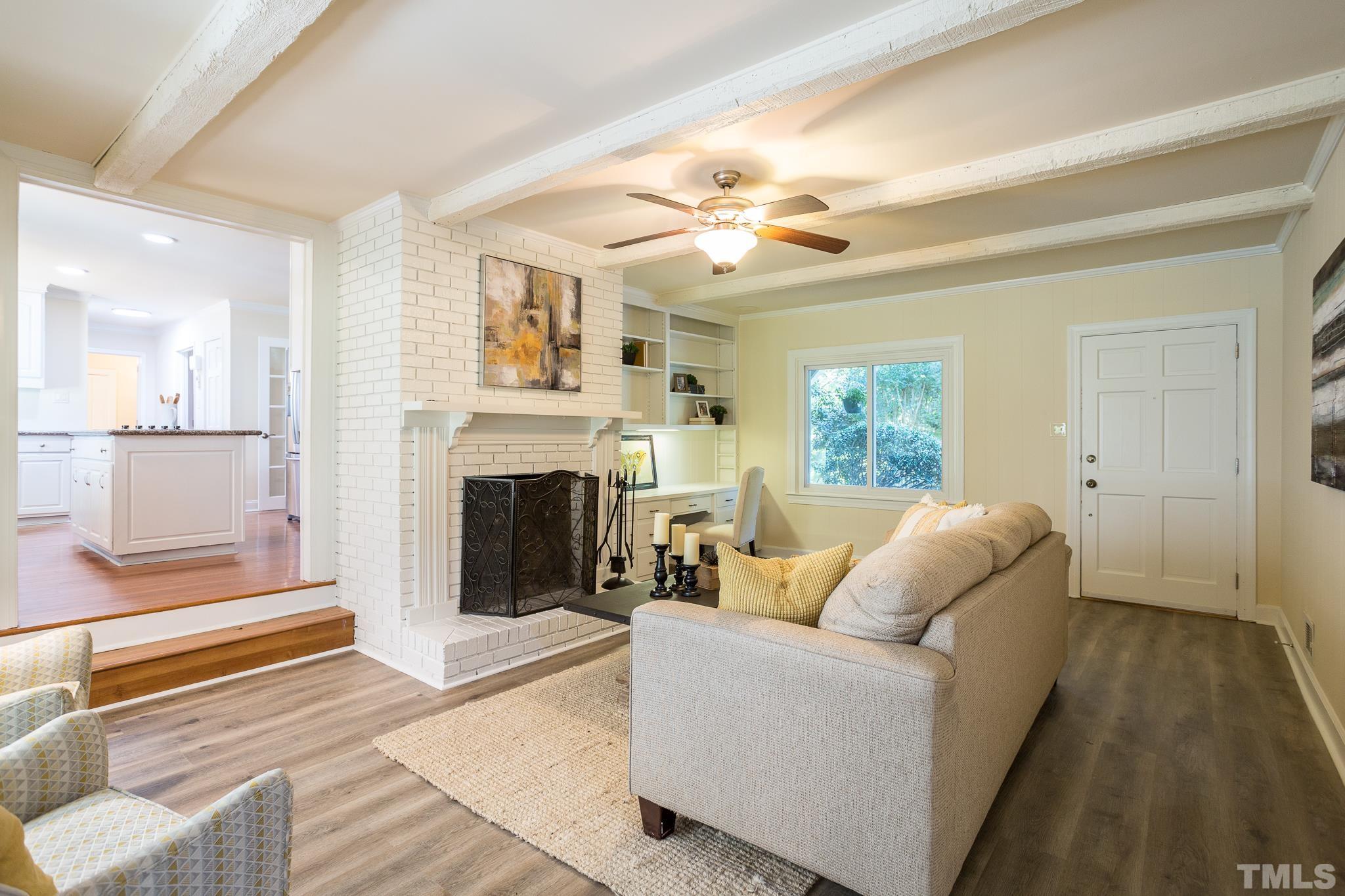 4608 Oak Park Road Raleigh, NC 27612 - Photo 12 of 30 a living room with furniture and a fireplace