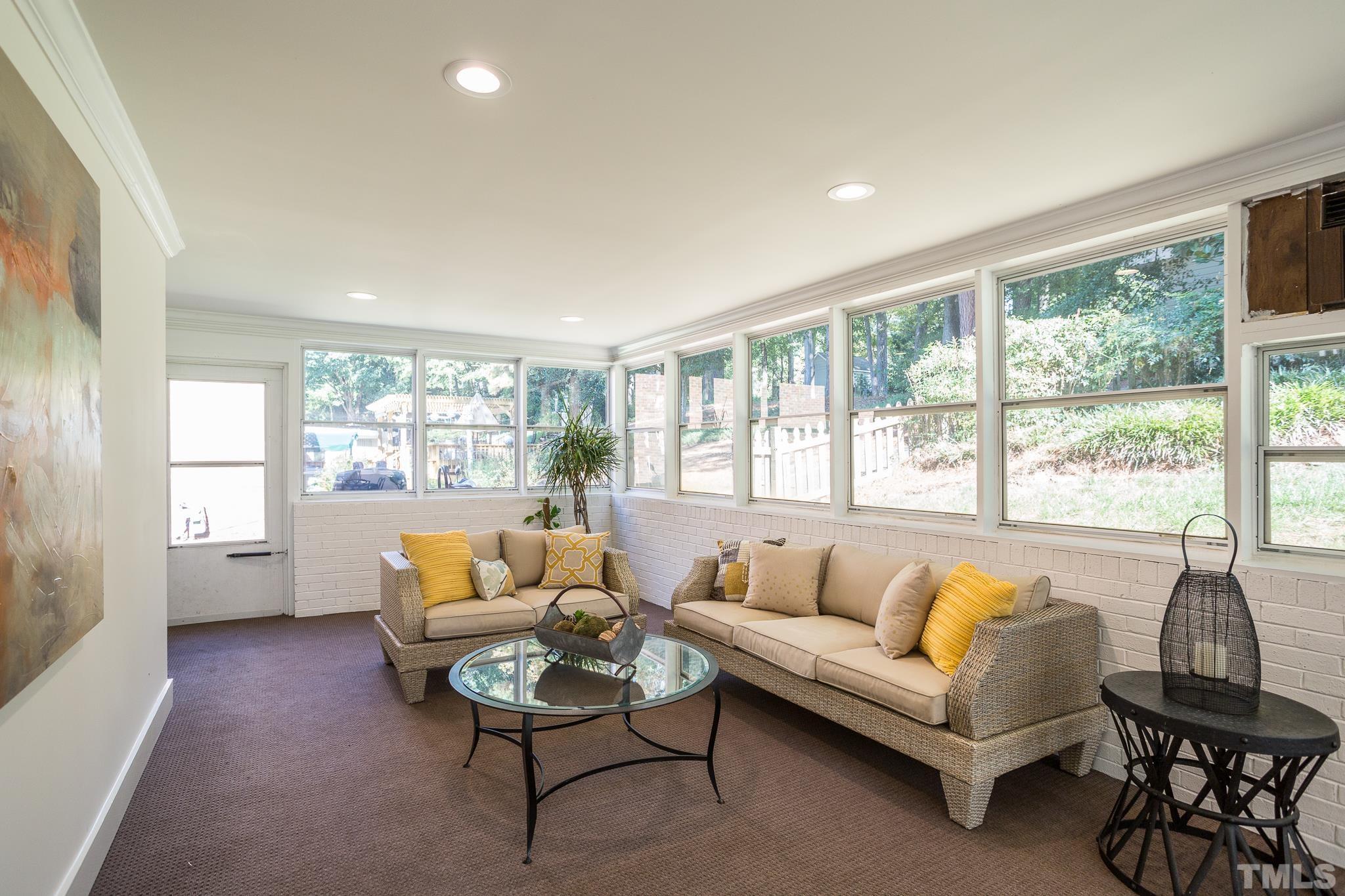4608 Oak Park Road Raleigh, NC 27612 - Photo 15 of 30 a living room with furniture and a large window