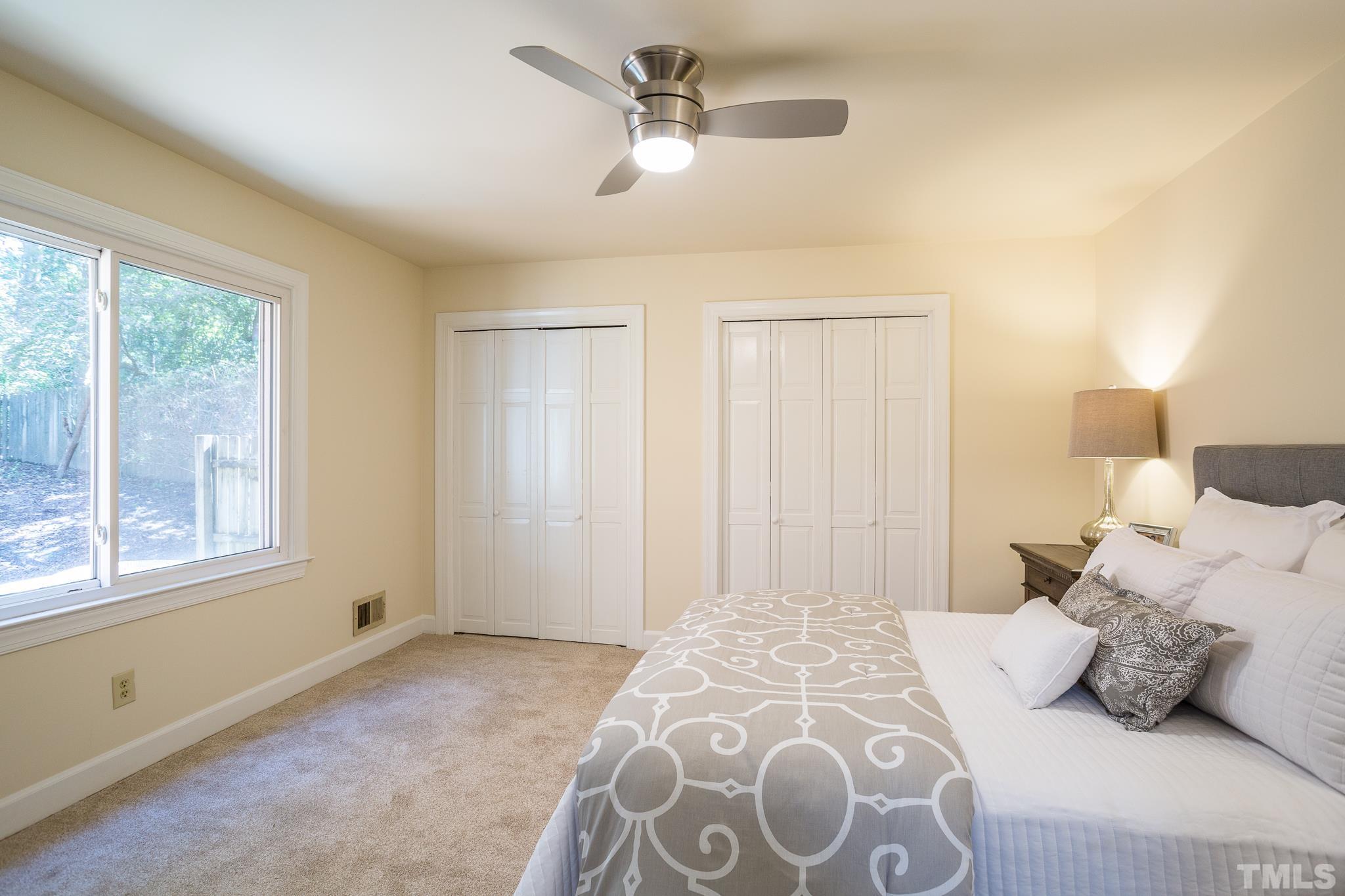 4608 Oak Park Road Raleigh, NC 27612 - Photo 17 of 30 a bedroom with a large bed and a window