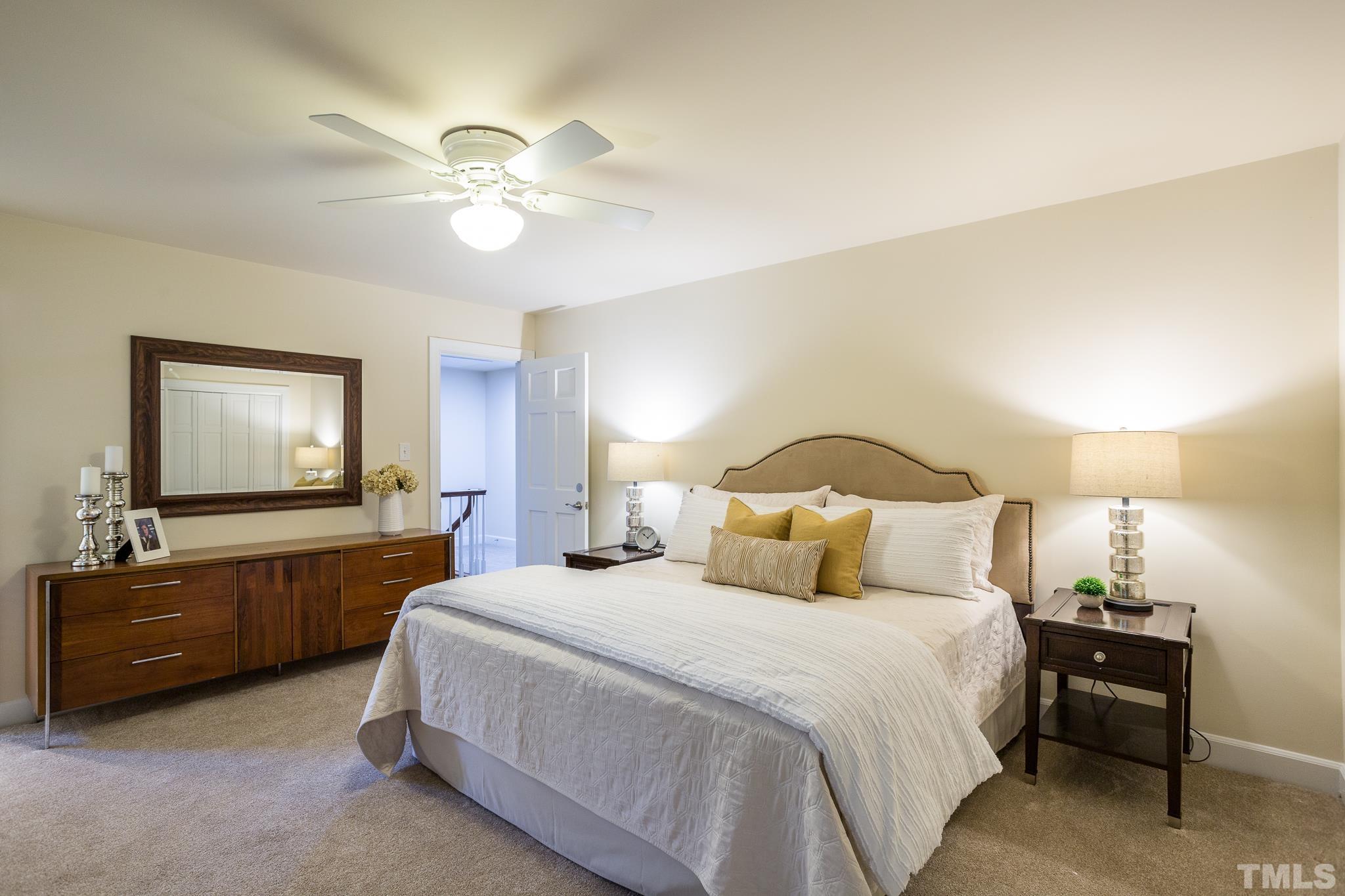 4608 Oak Park Road Raleigh, NC 27612 - Photo 19 of 30 a bedroom with a bed and a chandelier