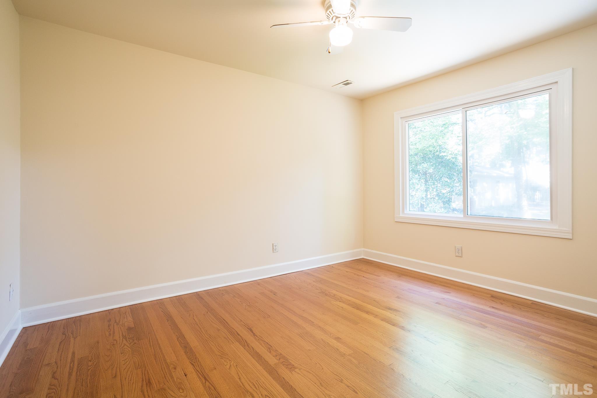 4608 Oak Park Road Raleigh, NC 27612 - Photo 22 of 30 wooden floor in an empty room with a window