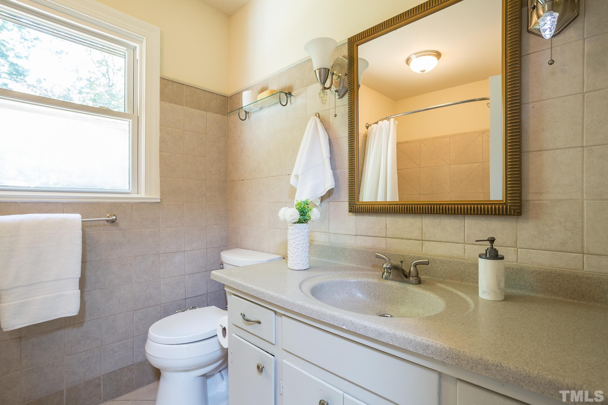 4608 Oak Park Road Raleigh, NC 27612 - Photo 23 of 30 a bathroom with a sink toilet and mirror
