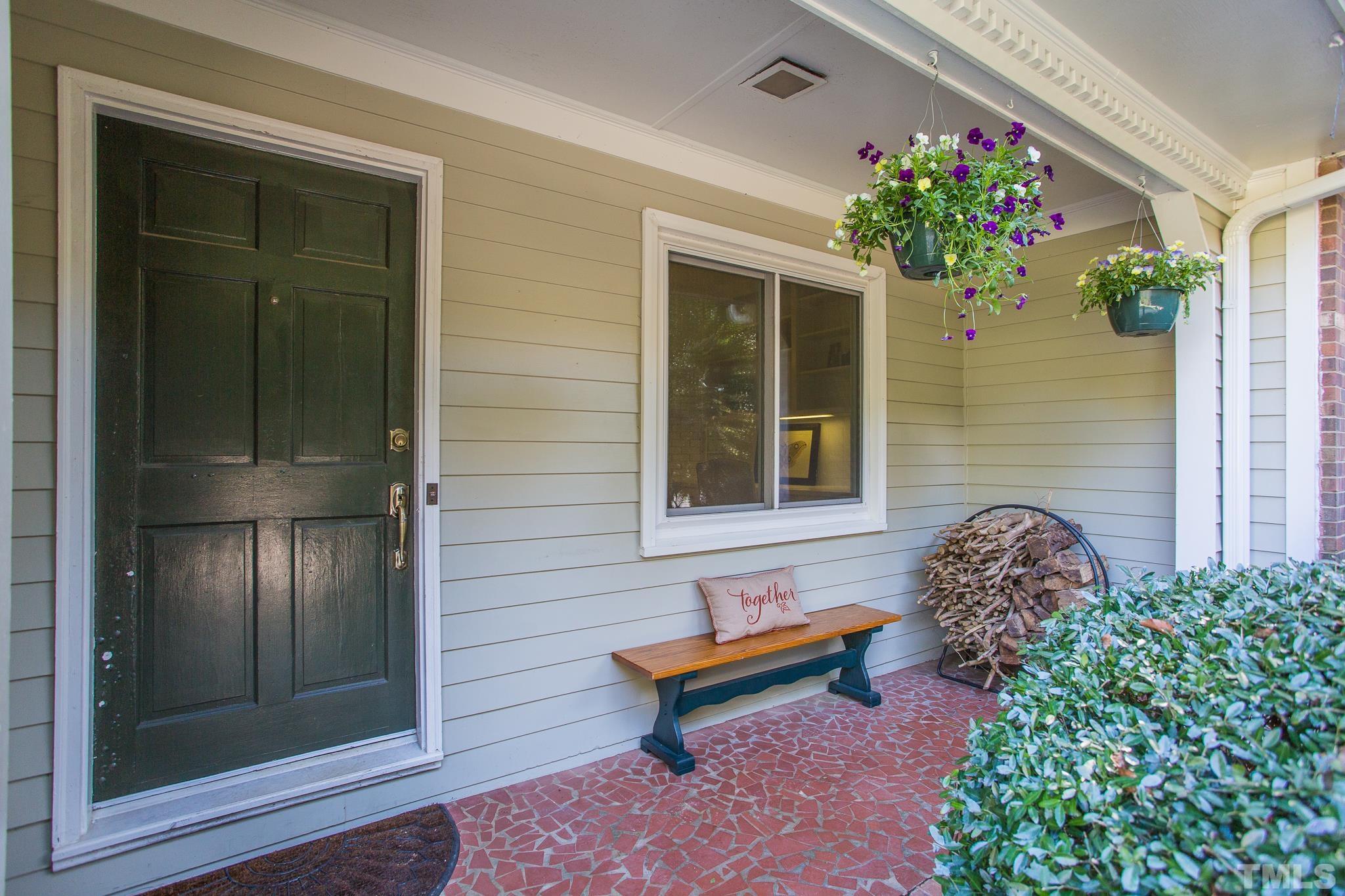 4608 Oak Park Road Raleigh, NC 27612 - Photo 4 of 30 a bench sitting in front of a house