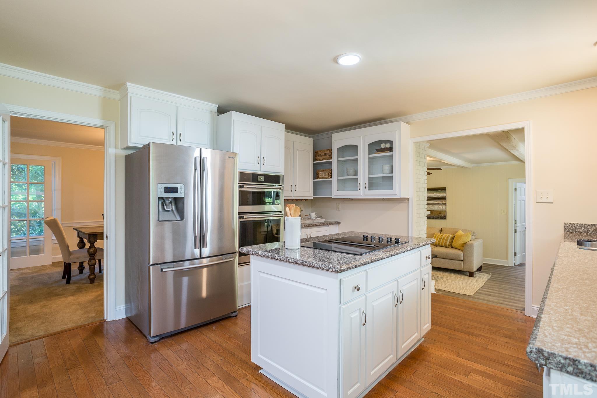 4608 Oak Park Road Raleigh, NC 27612 - Photo 7 of 30 a kitchen with stainless steel appliances a refrigerator sink and cabinets