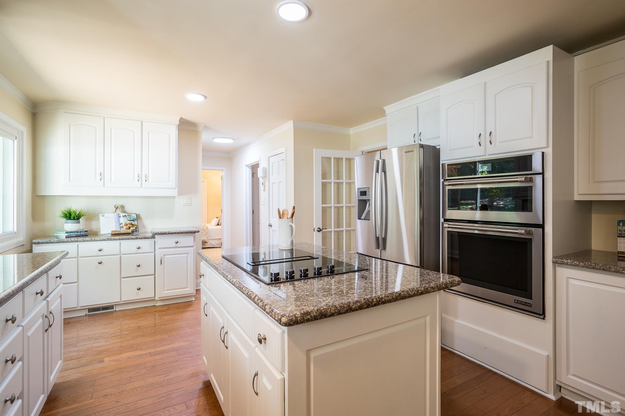 4608 Oak Park Road Raleigh, NC 27612 - Photo 9 of 30 a kitchen with granite countertop white cabinets and stainless steel appliances