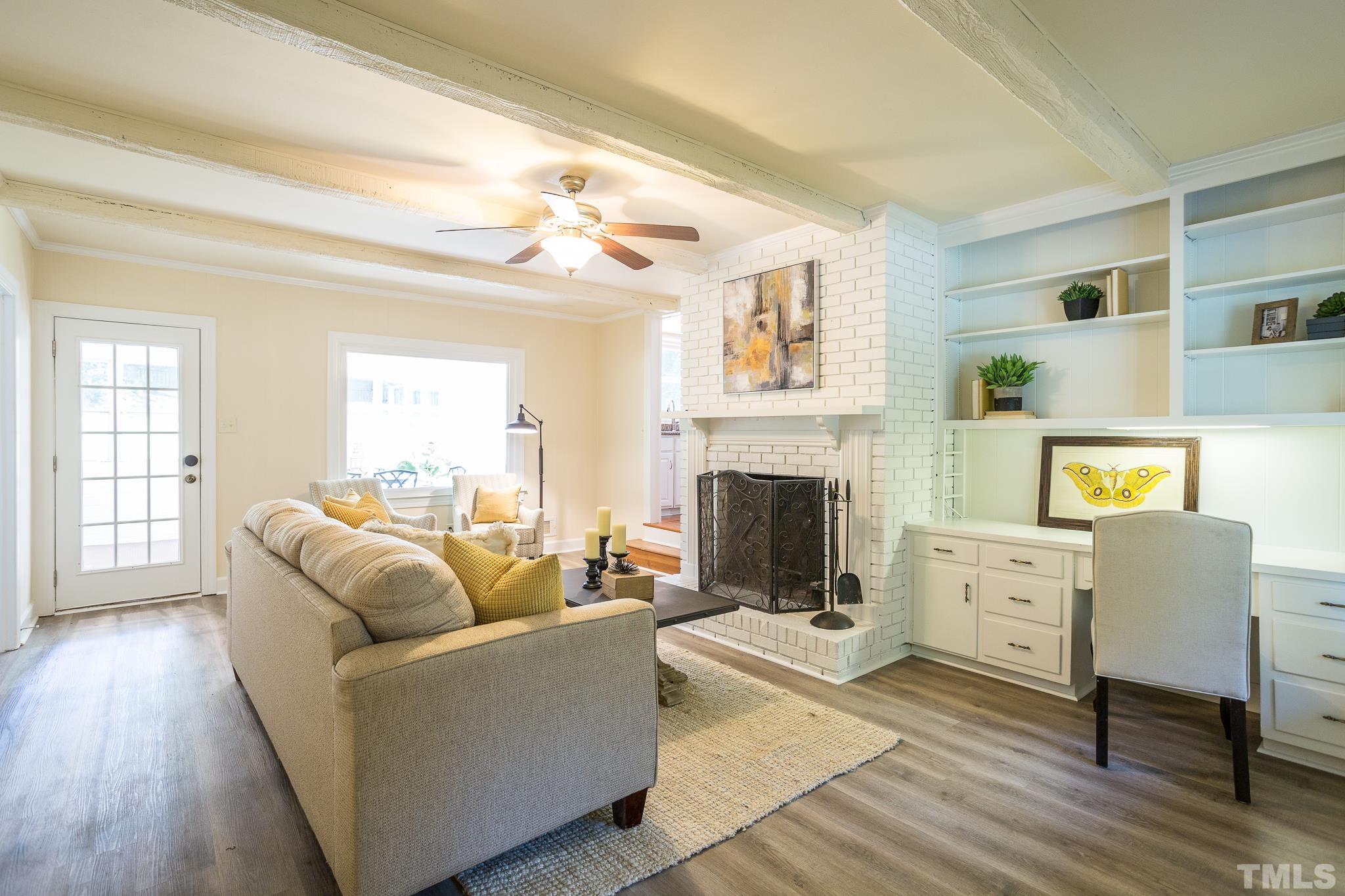 4608 Oak Park Road Raleigh, NC 27612 - Photo 10 of 30 a living room with furniture and a fireplace