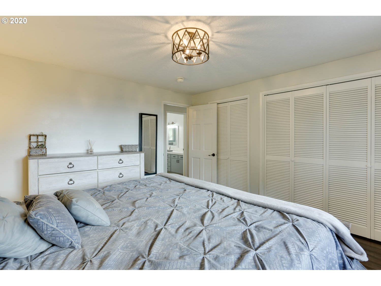 33672 Southwest Laurel Road Hillsboro, OR 97123 - Photo 13 of 32 a bedroom with a bed and a chandelier