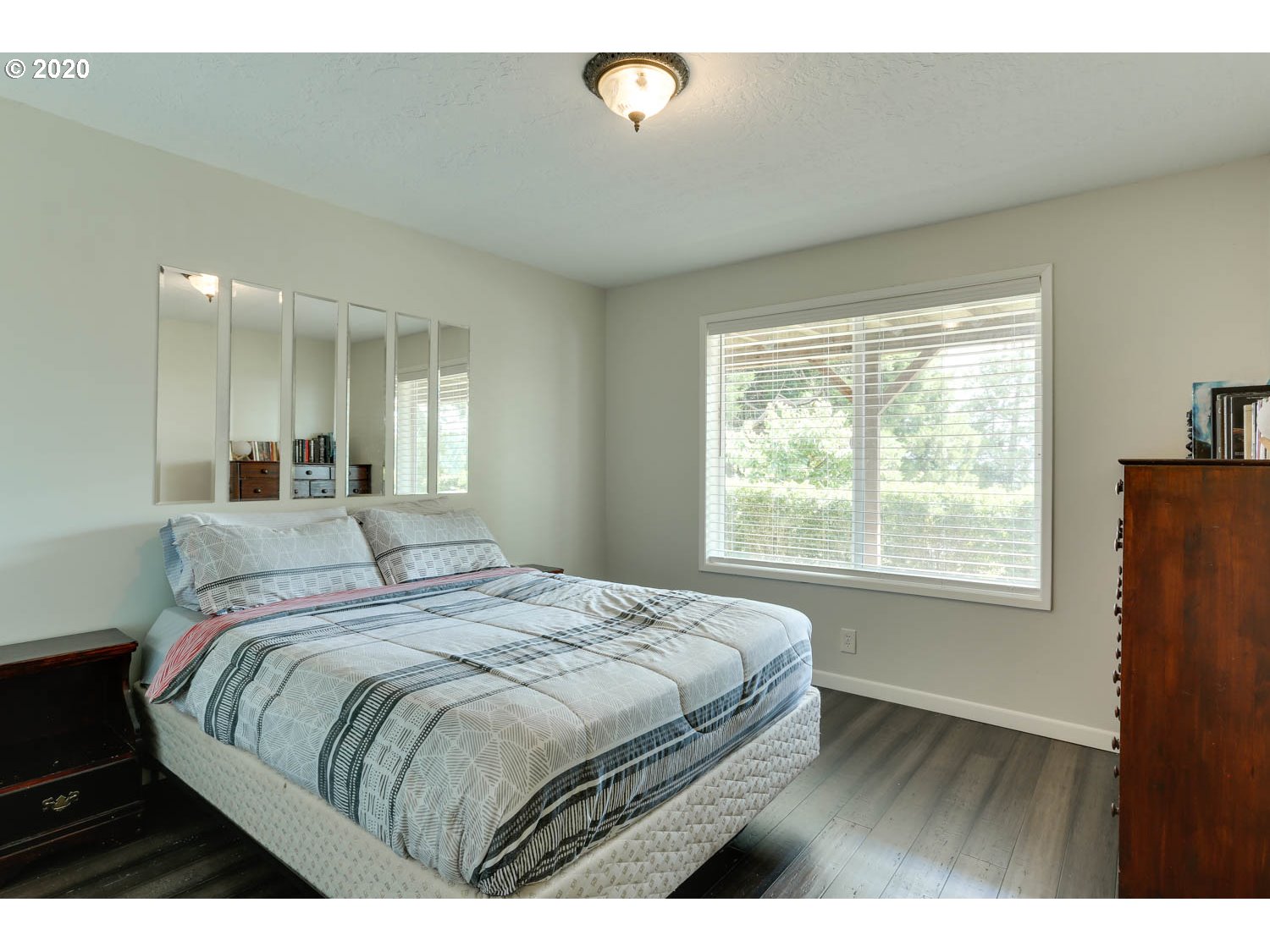 33672 Southwest Laurel Road Hillsboro, OR 97123 - Photo 15 of 32 a bed sitting in a bedroom next to a window