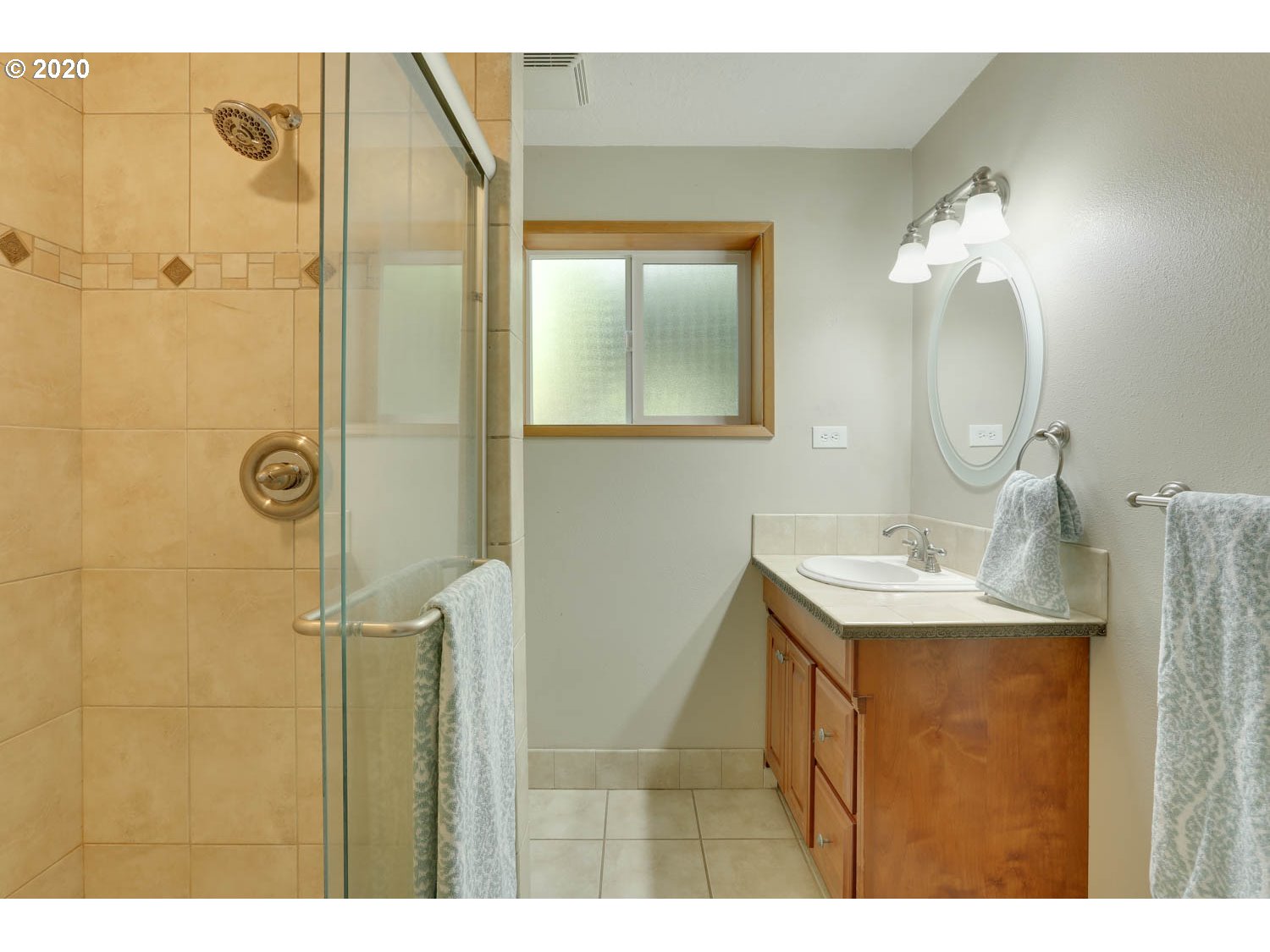 33672 Southwest Laurel Road Hillsboro, OR 97123 - Photo 16 of 32 a bathroom with a granite countertop sink a mirror and shower
