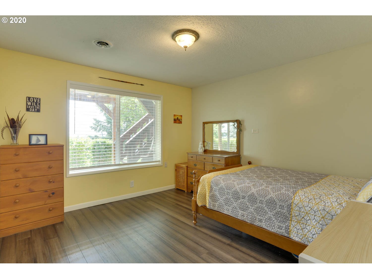 33672 Southwest Laurel Road Hillsboro, OR 97123 - Photo 17 of 32 a bedroom with a bed and a dresser with wooden floor