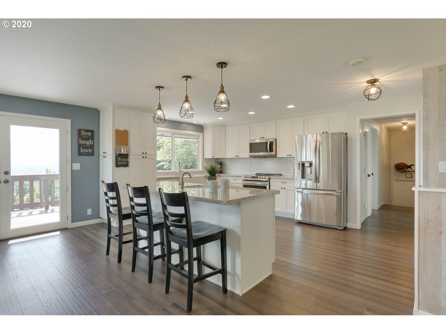 33672 Southwest Laurel Road Hillsboro, OR 97123 - Photo 7 of 32 a kitchen with stainless steel appliances kitchen island granite countertop a dining table chairs and granite counter tops