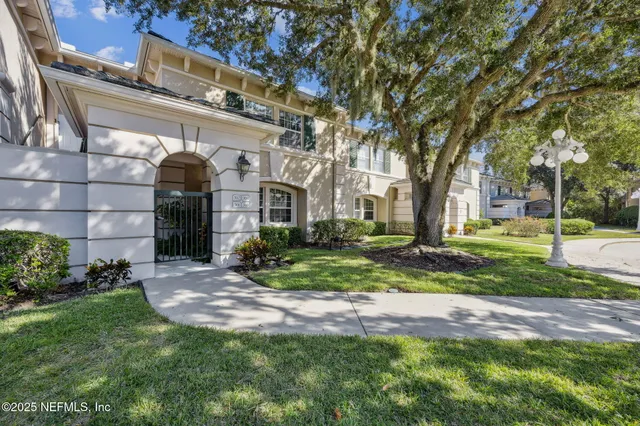 a view of a house with a yard and plants