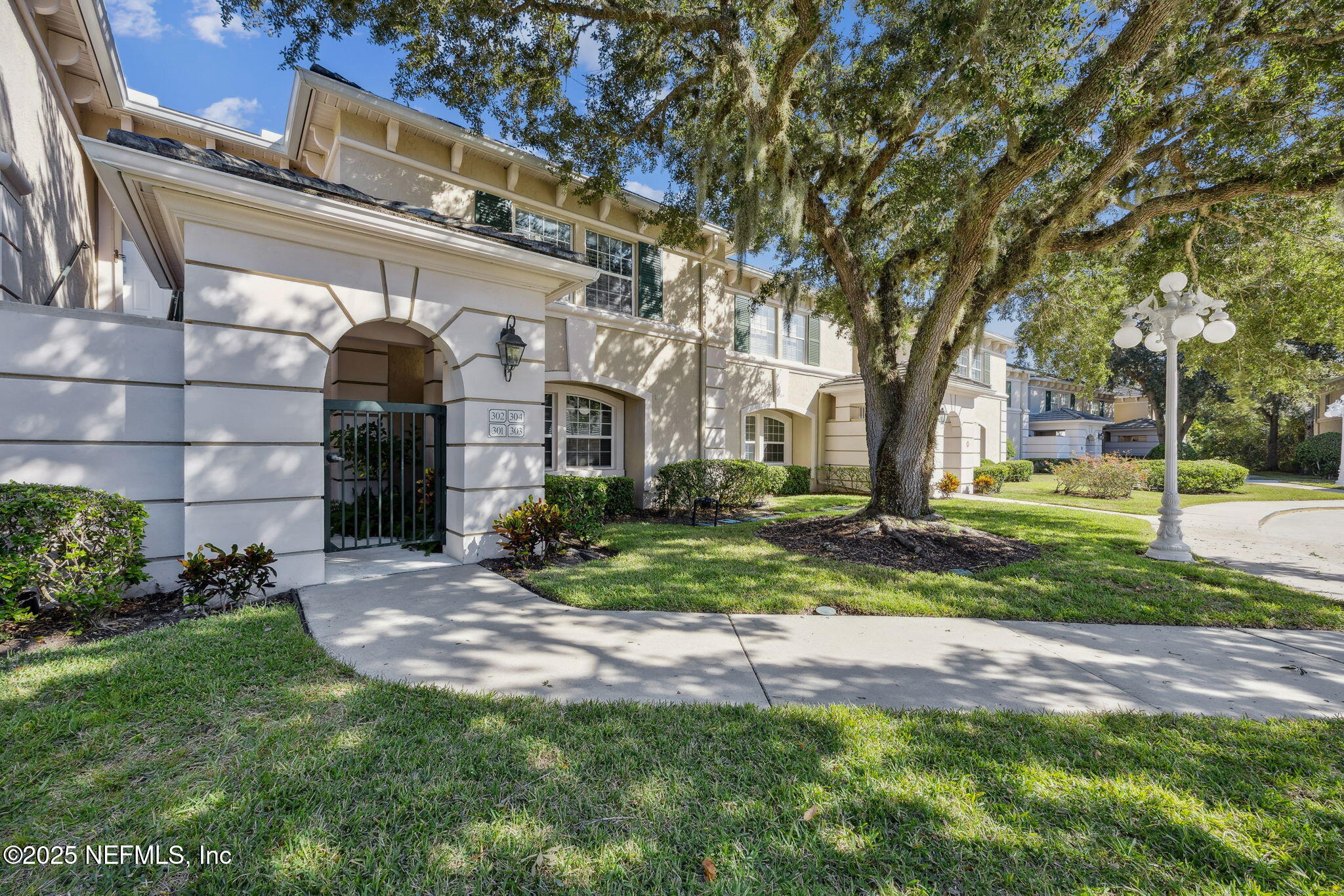 300 Bermuda Bay Circle, Unit 304 Ponte Vedra Beach, FL 32082 - Photo 1 of 42 a view of a house with a yard and plants