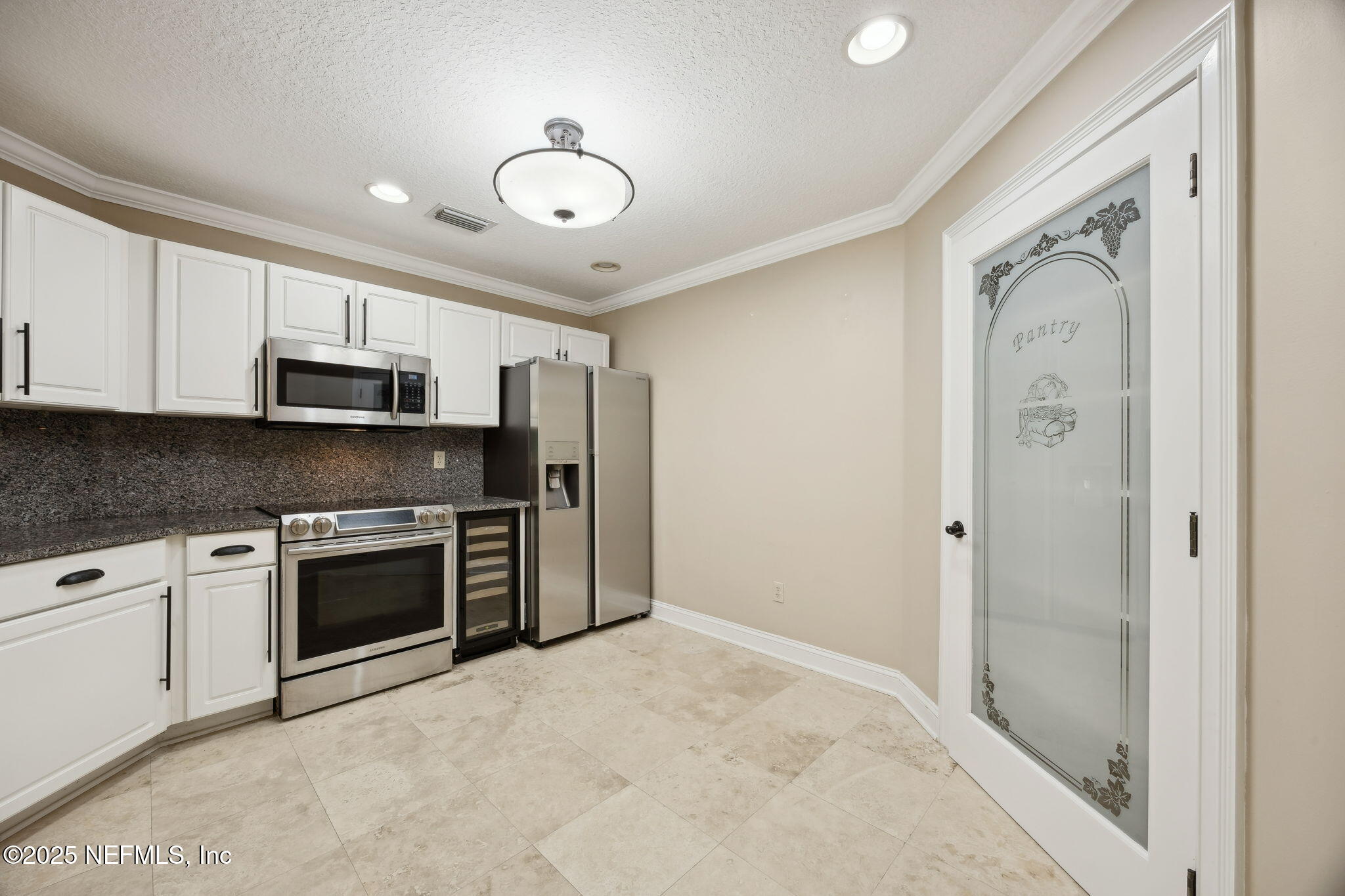 300 Bermuda Bay Circle, Unit 304 Ponte Vedra Beach, FL 32082 - Photo 11 of 42 a kitchen with stainless steel appliances granite countertop a refrigerator and a stove top oven